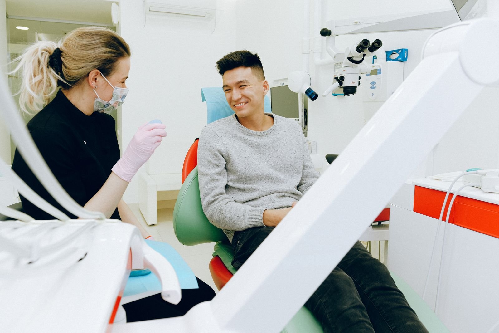 Meridian dentist consulting a smiling patient